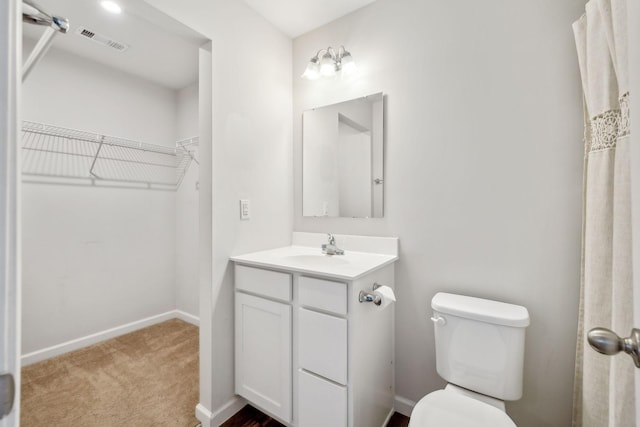 bathroom featuring vanity and toilet