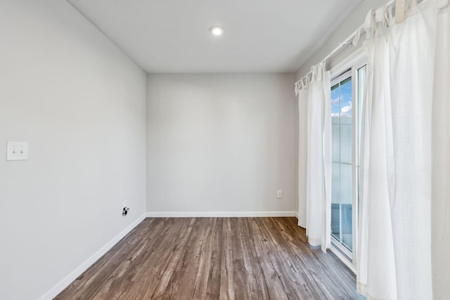 spare room with dark hardwood / wood-style flooring