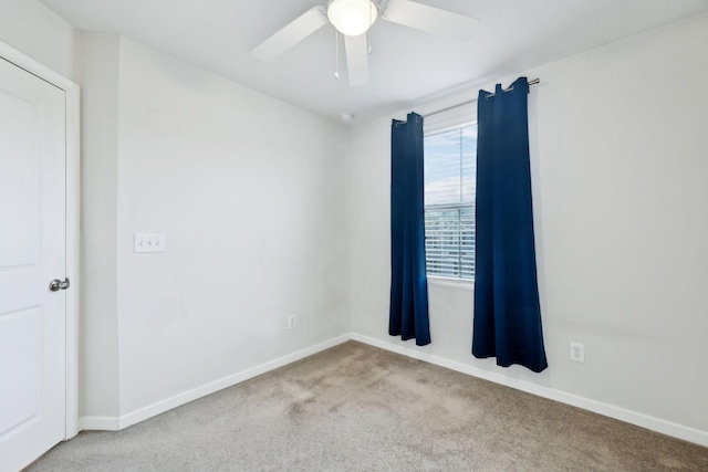 empty room with light colored carpet and ceiling fan