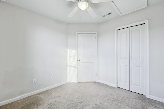 unfurnished bedroom with ceiling fan, light colored carpet, and a closet