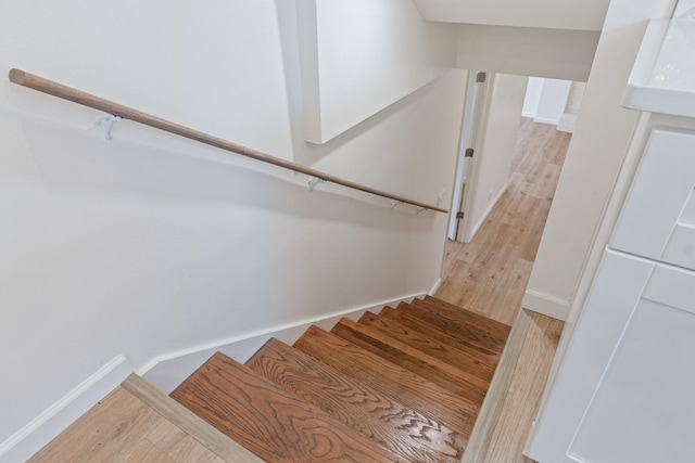 stairway with hardwood / wood-style flooring