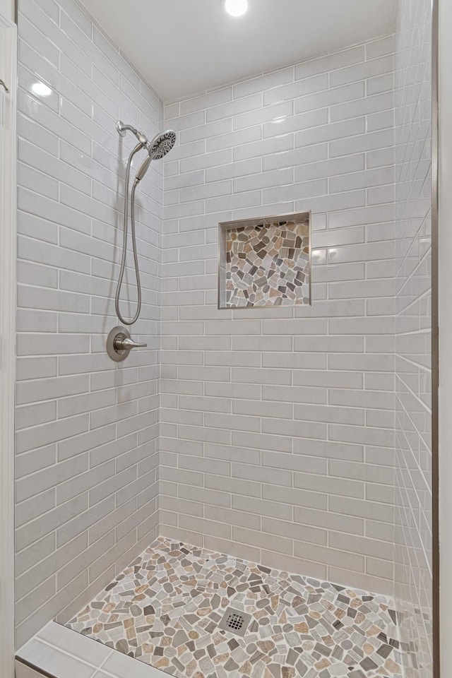 bathroom with a tile shower