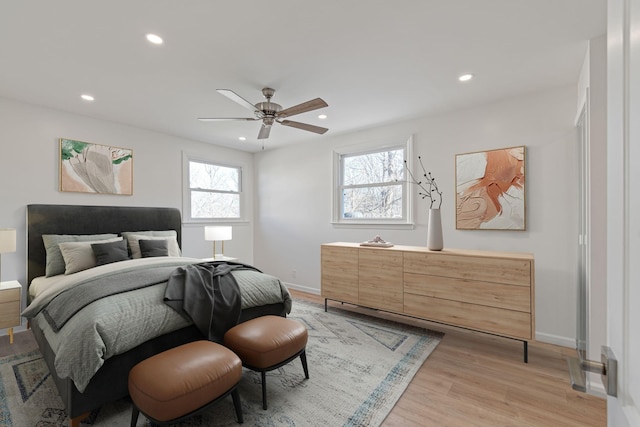 bedroom with ceiling fan and light hardwood / wood-style floors