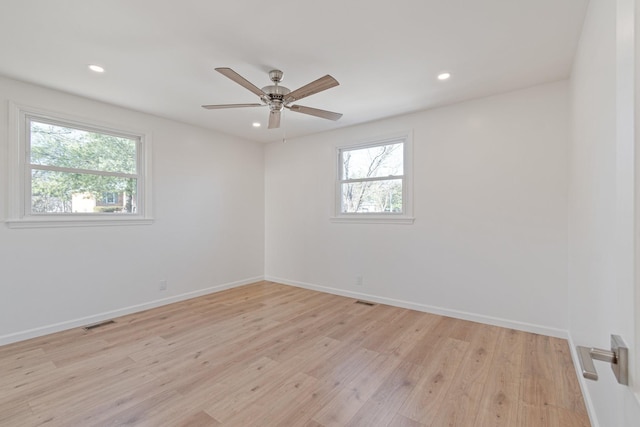 unfurnished room featuring ceiling fan, light hardwood / wood-style flooring, and a healthy amount of sunlight