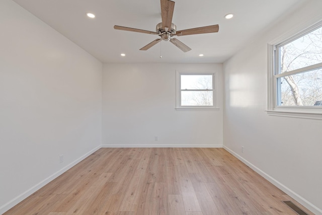 spare room with light hardwood / wood-style flooring and ceiling fan