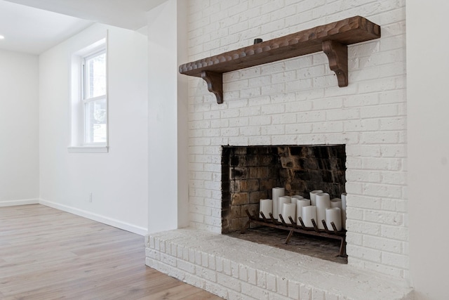 details featuring a brick fireplace and hardwood / wood-style flooring