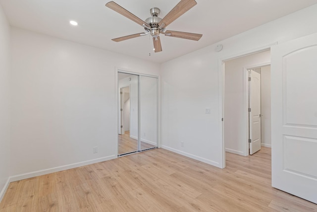 unfurnished bedroom with light hardwood / wood-style flooring, a closet, and ceiling fan