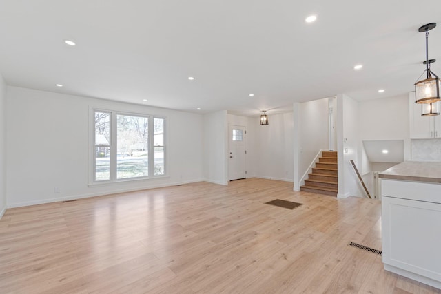 unfurnished living room featuring light hardwood / wood-style floors