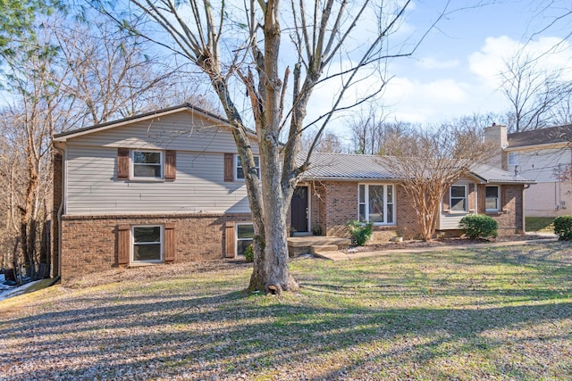 tri-level home with a front lawn