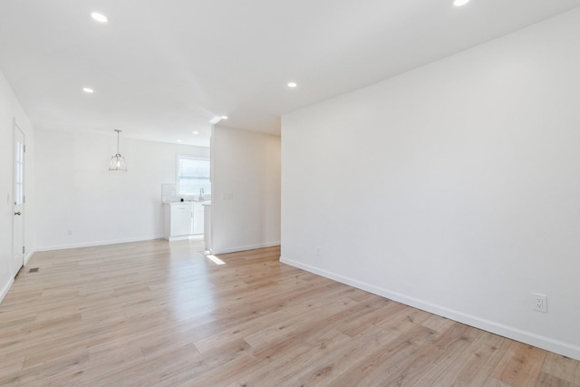 spare room with light hardwood / wood-style flooring