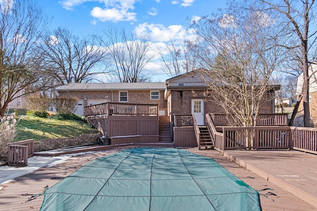 back of property featuring a swimming pool side deck