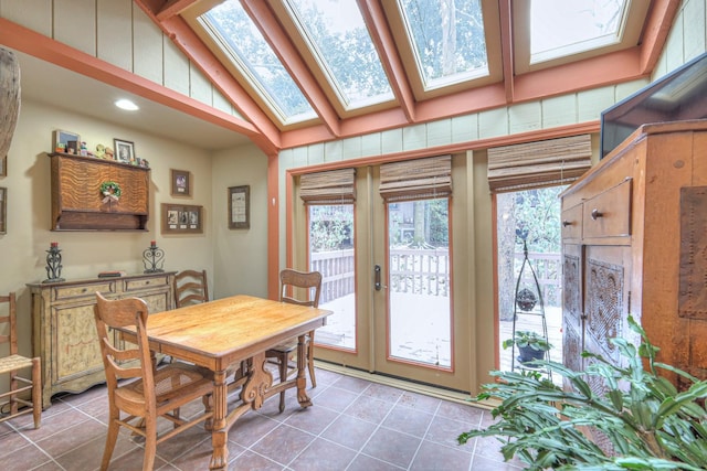 tiled dining space with high vaulted ceiling and french doors