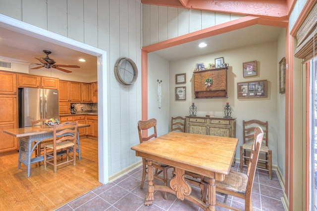 dining area featuring ceiling fan and tile patterned flooring