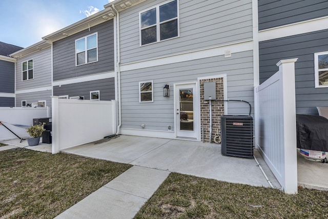 rear view of property with a yard, central AC, and a patio