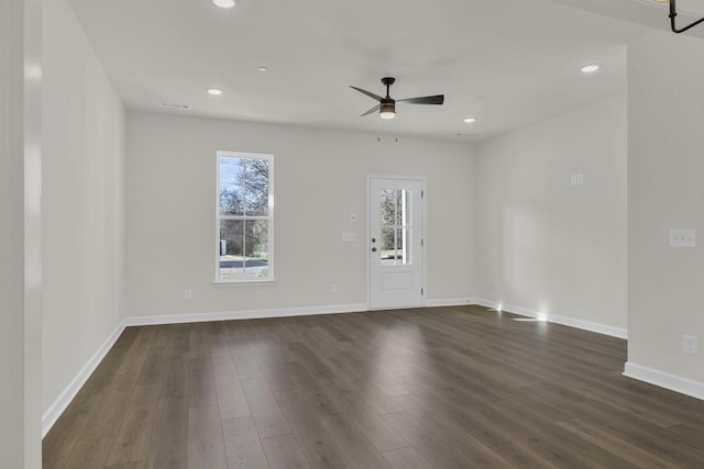 unfurnished room with dark wood-type flooring and ceiling fan