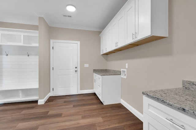 interior space featuring crown molding, cabinets, hookup for a washing machine, and dark hardwood / wood-style floors