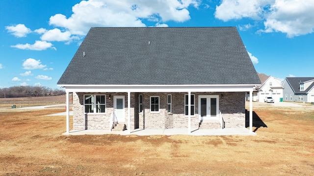 rear view of house with a patio and a lawn