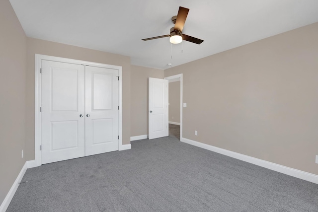 unfurnished bedroom featuring a closet, ceiling fan, and dark colored carpet