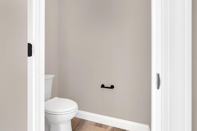 bathroom featuring hardwood / wood-style floors and toilet