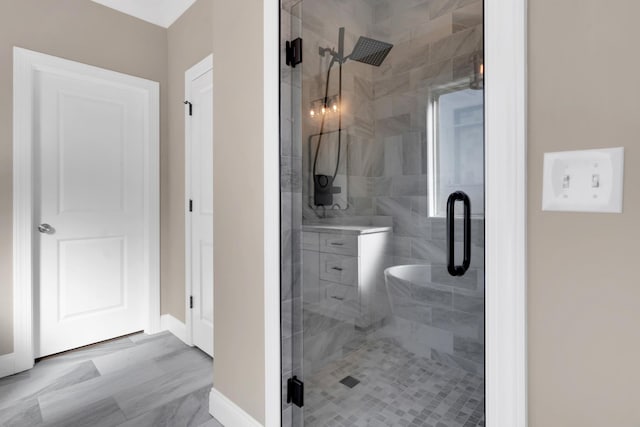 bathroom with a shower with door