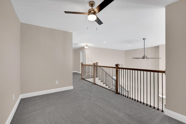 carpeted spare room featuring ceiling fan