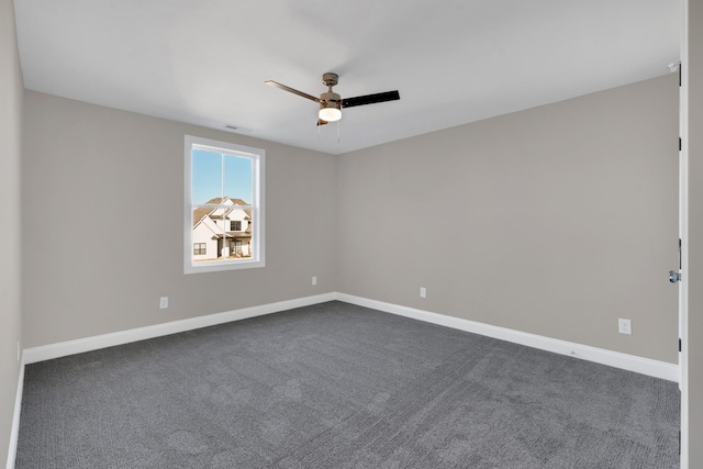 carpeted spare room with ceiling fan