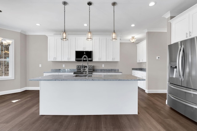 kitchen featuring stainless steel refrigerator with ice dispenser, white cabinetry, hanging light fixtures, and a center island with sink