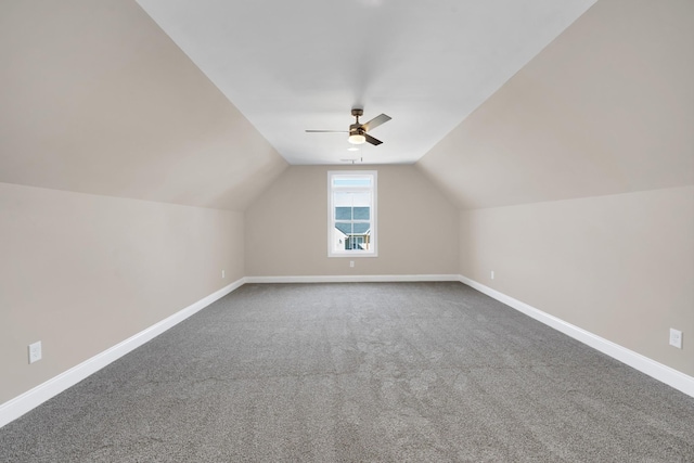 additional living space featuring ceiling fan, lofted ceiling, and carpet floors