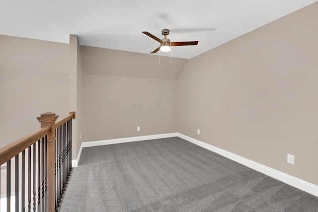 carpeted empty room featuring vaulted ceiling and ceiling fan