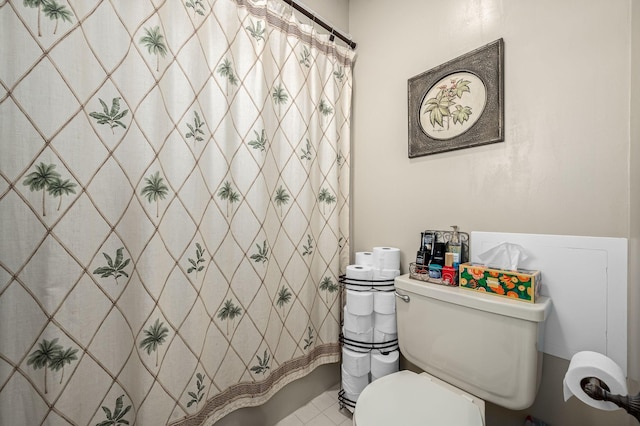 bathroom featuring curtained shower and toilet