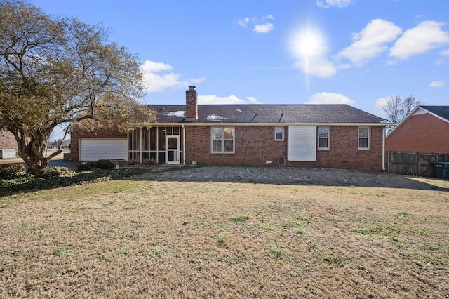 rear view of property featuring a lawn and a sunroom