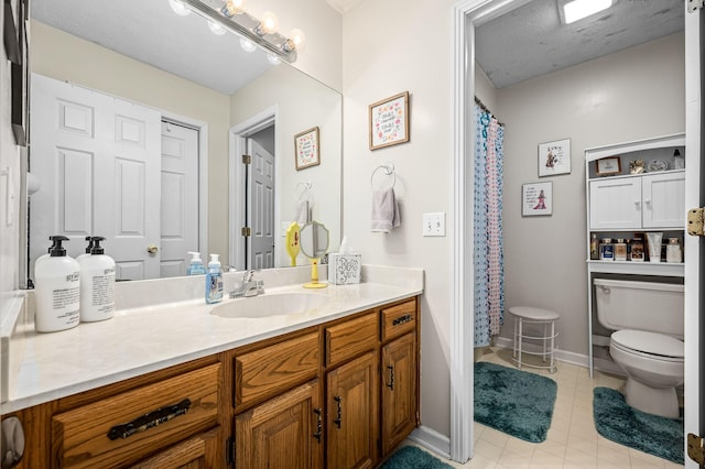 bathroom featuring vanity, a textured ceiling, and toilet