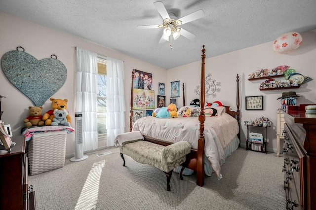 carpeted bedroom with a textured ceiling and ceiling fan