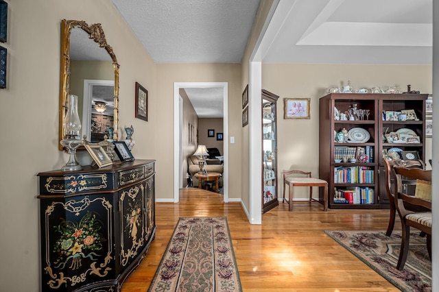 interior space with a textured ceiling and light hardwood / wood-style floors