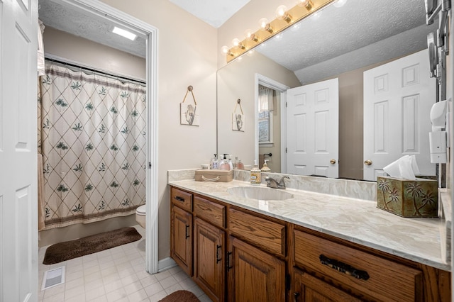 bathroom featuring vanity, toilet, curtained shower, and a textured ceiling