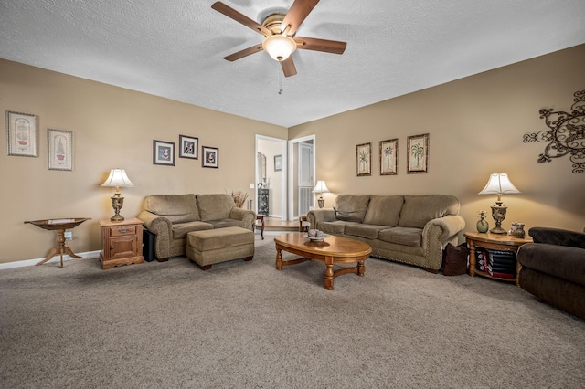 living room featuring ceiling fan, carpet flooring, and a textured ceiling