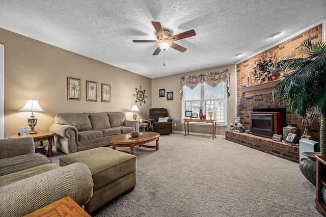 living room featuring ceiling fan, carpet flooring, a brick fireplace, and a textured ceiling