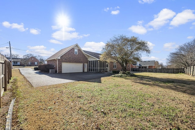 view of home's exterior featuring cooling unit, a garage, and a yard