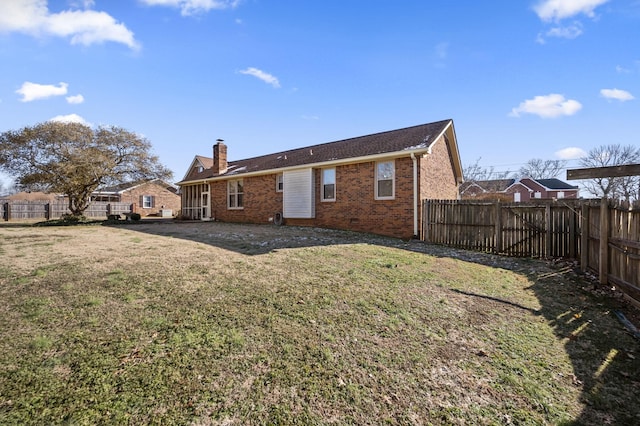 rear view of house with a lawn