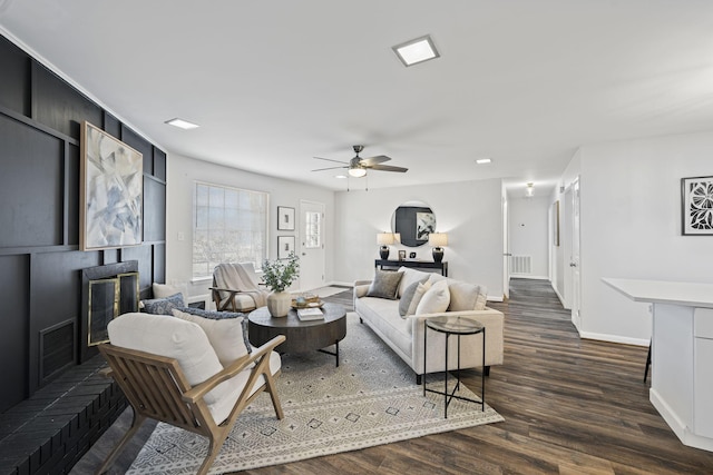 living room with dark hardwood / wood-style floors and ceiling fan