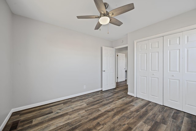 unfurnished bedroom featuring dark hardwood / wood-style floors, a closet, and ceiling fan