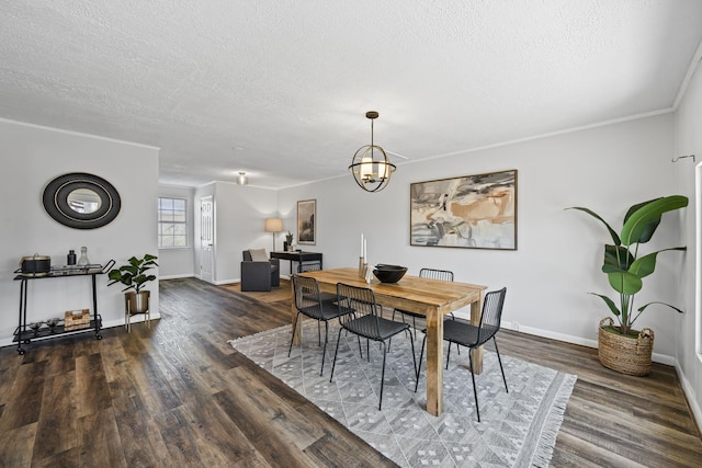 dining area featuring a textured ceiling, dark wood-type flooring, and a chandelier