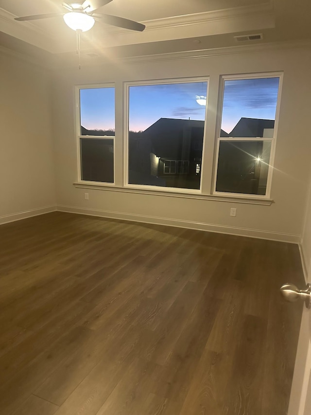 empty room with ornamental molding, dark hardwood / wood-style floors, and ceiling fan