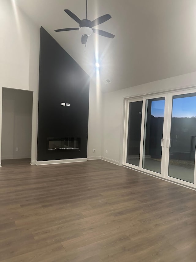 unfurnished living room featuring wood-type flooring, high vaulted ceiling, french doors, and ceiling fan