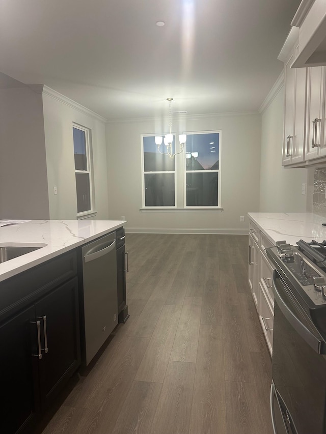 kitchen with white cabinetry, stainless steel dishwasher, decorative light fixtures, and stove