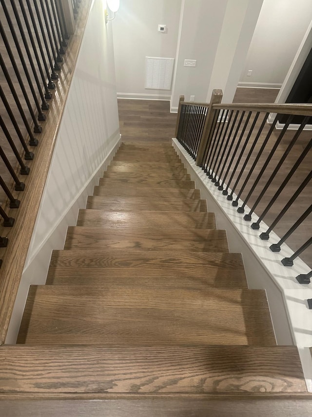 stairway featuring hardwood / wood-style floors