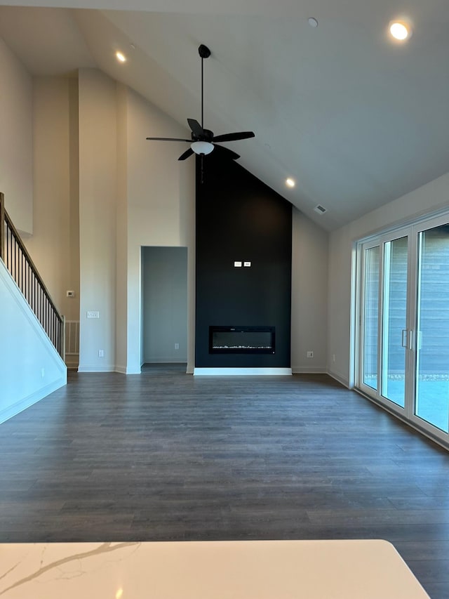 unfurnished living room with dark hardwood / wood-style flooring, high vaulted ceiling, and ceiling fan