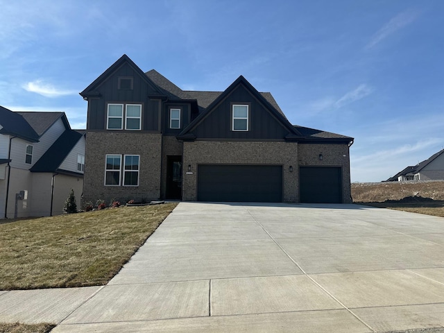 view of front of home with a garage and a front lawn