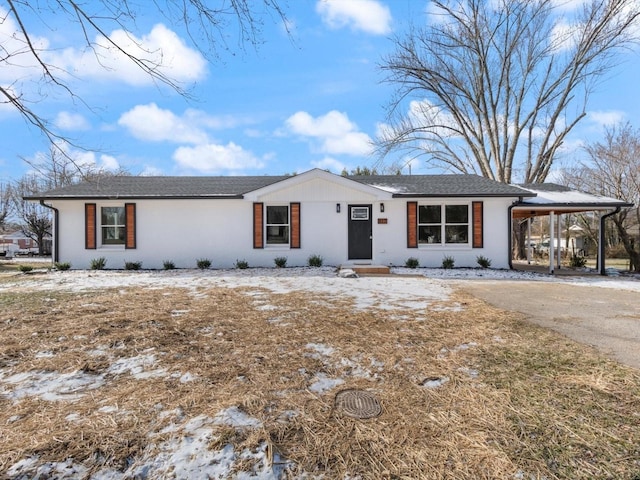 ranch-style home featuring a carport