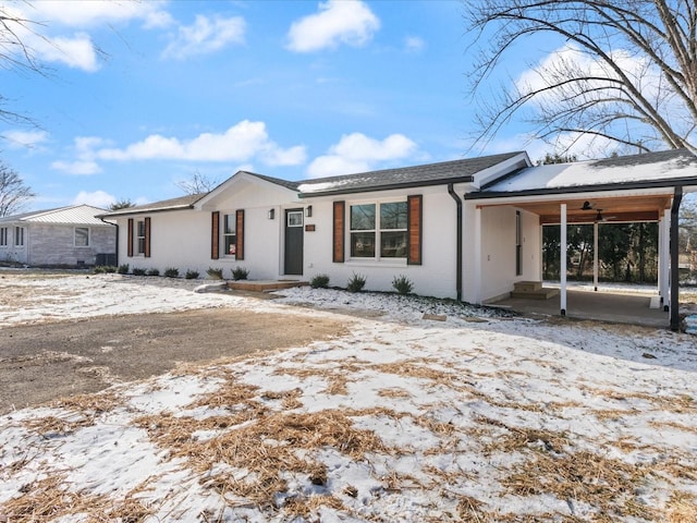 single story home featuring a carport and ceiling fan